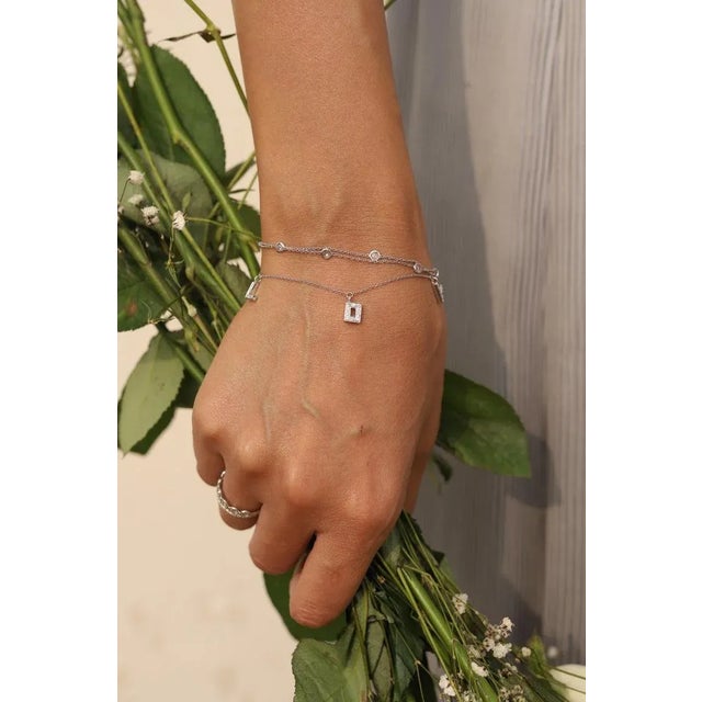 This is part of Chairish’s Fine Jewelry assortment. This Diamond Love Charm Bracelet in 18K gold showcases sparkling...
