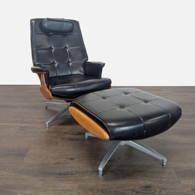 This Heywood-Wakefield lounge chair and ottoman set features sleek black leather upholstery with button tufting and...