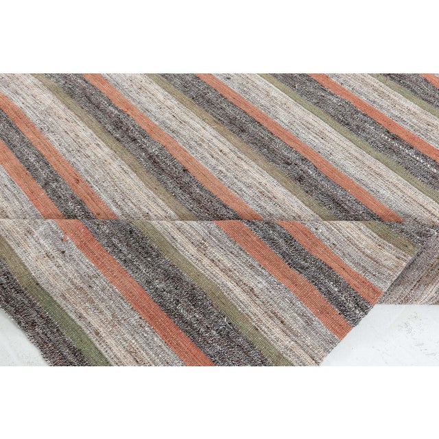 Vintage Persian Kilim Rug Size: 5'0" × 8'3" (152 × 251 cm) This striking 1956 Vintage Persian Kilim rug presents a...