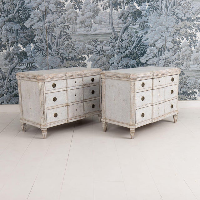 A beautiful pair of Swedish Gustavian breakfront chests from the 19th century, framed by dentil molding. There are three...