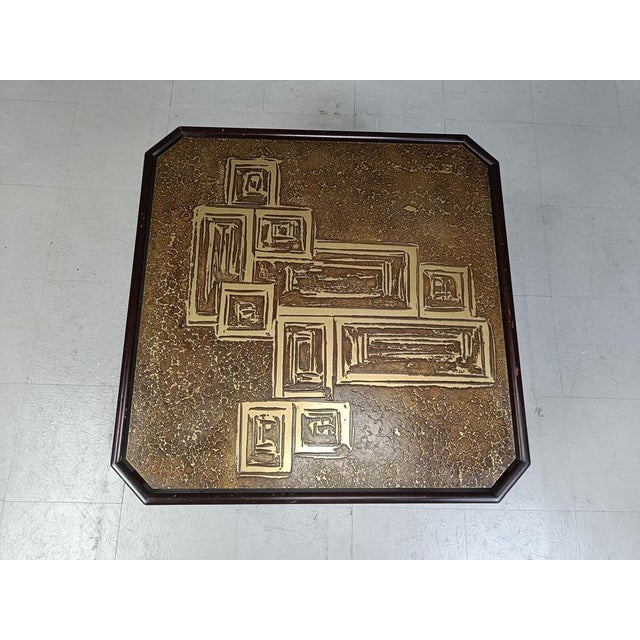 Square side table with an etched brass top and brown stained wooden frame. Cool brutalist style motive in the brass. 1970s...