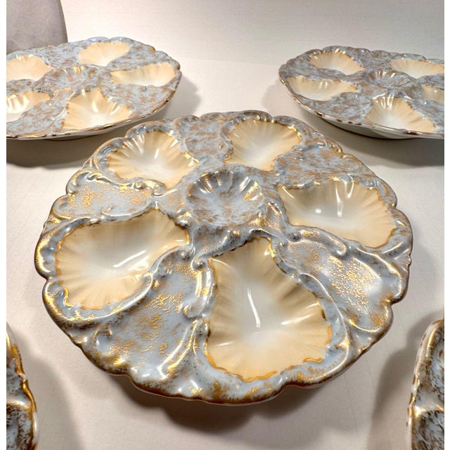 A beautiful and increasingly rare set of five antique French oyster plates by Limoges, each with softly scalloped wells...