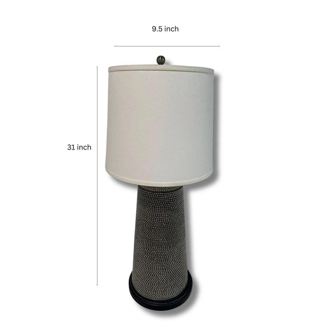 This modern table lamp is one of a kind. It has a black base with silver polished accents. Minimalistic and trendy adds...