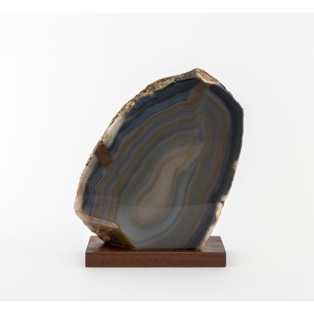 Polished Banded Agate Mineral Specimen, mounted on a walnut base. 10" H x 8" W x 3.75" D. Provenance: From a New York City...
