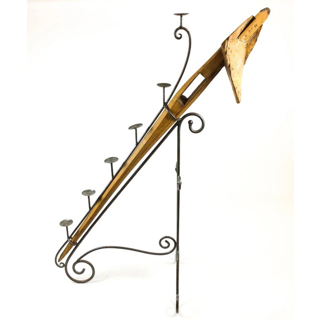 Magnificent large work of art using an antique wooden farm plow from Vietnam. A skilled artisan-made wrought iron holder...