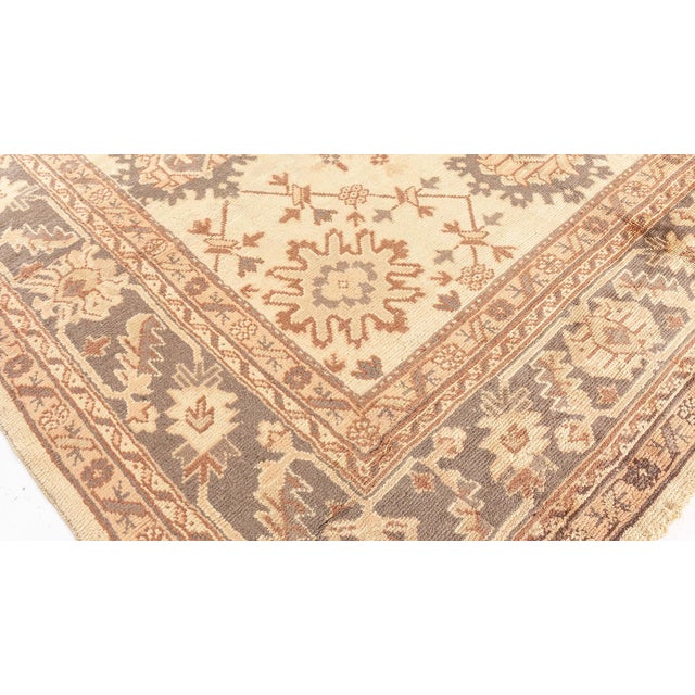 This rare square-shaped antique Turkish Oushak rug is a magnificent example of Anatolian weaving from the early 20th...