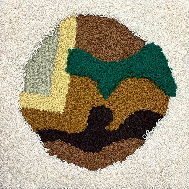 A 1976 wool tapestry by American artist Harry Hilson (1935-2004). This work features a central circle composition with...