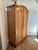 Vintage European pine armoire with newly added interior shelving and ball feet. Interior features solid wood shelves...