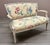 A French Country style settée, upholstered in a wonderful floral polished cotton. Wood has been painted white and is...