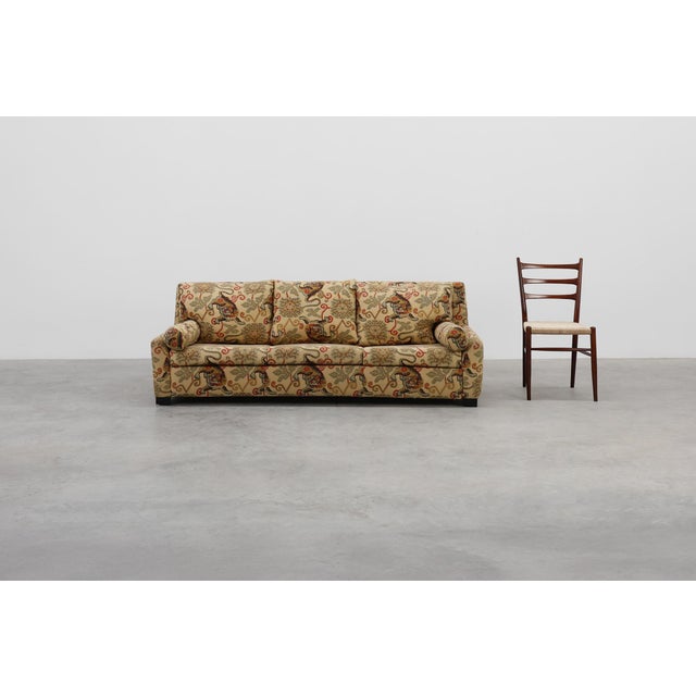 A bold and charismatic statement piece, this Hollywood Regency sofa from Italy circa 1990 pairs sculptural form with...