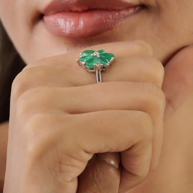 Crafted in 925 sterling silver, this elegant floral cocktail ring showcases 3.05 carats of natural pear and marquise-cut...
