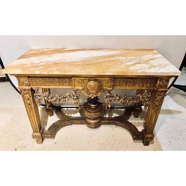 A fine turn of the century Louis XV style giltwood marble-top console table with urn form undercarriage. This fine...