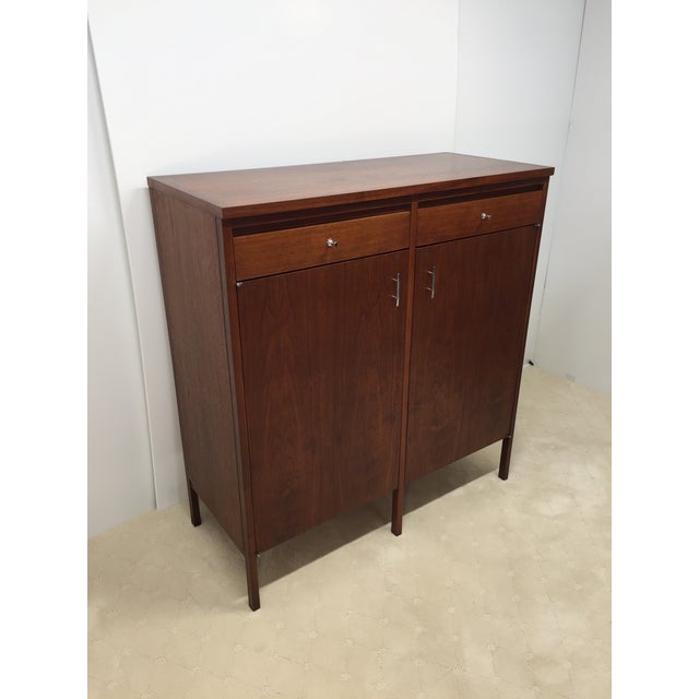 Rare and wonderful Paul McCobb designed high chest of drawers with fitted interior behind two doors. This Lane model is...