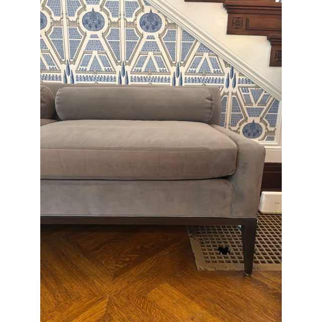 Upholstered bench features an eclectic blend of straight lines and curves, with flat arms and front coming together with a...
