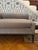 Upholstered bench features an eclectic blend of straight lines and curves, with flat arms and front coming together with a...