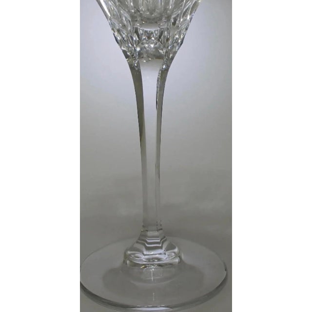 A refined set of six Mikasa “Arctic Lights” crystal wine goblets, featuring a sculptural vertical cut pattern and luminous...