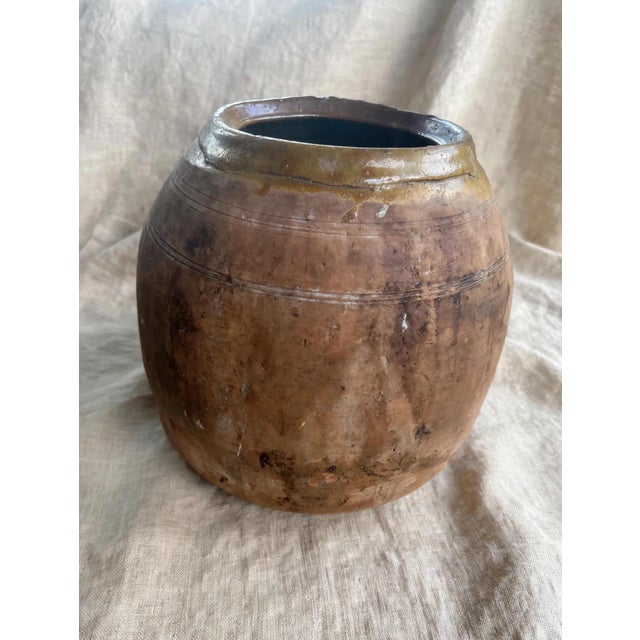 A stunning, large-scale antique terracotta storage jar with incredible patina and presence. This bulbous, hand-thrown...