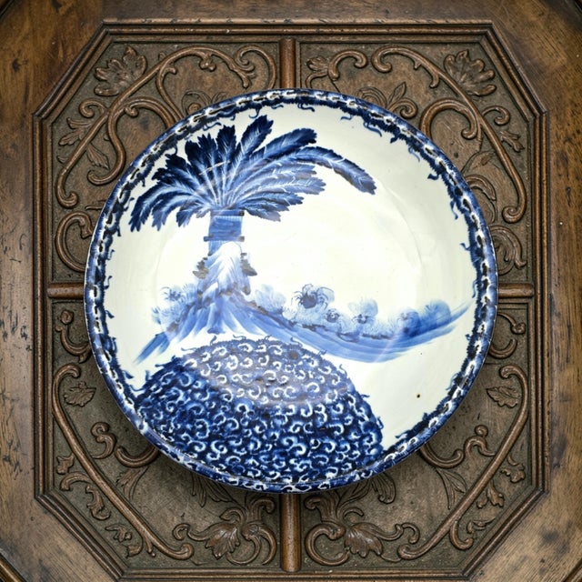 A generously scaled blue and white porcelain charger rendered in the Chinese export tradition, hand painted in fluid...