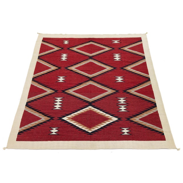 Elevate your space with this stunning Modern Navajo Style wool rug, featuring a vibrant crimson field adorned with bold,...