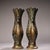 A striking matching pair of archaic-style bronze vases adorned with finely inlaid gold wire forming elaborate peacock...