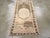 A vintage Turkish Oushak throw rug. The field strongly abrashes from medium-dark brown to beige n this narrow west...