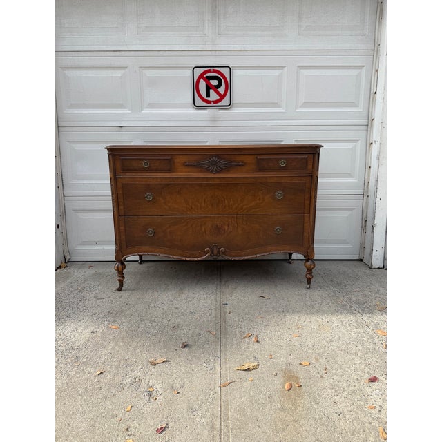 We have an absolutely beautiful antique Victorian Revival walnut dresser for sale. This elegant three drawer chest...