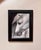 Penumbra features a close-up portrayal of a horse, its soft, flowing mane contrasting against a dark background. The...