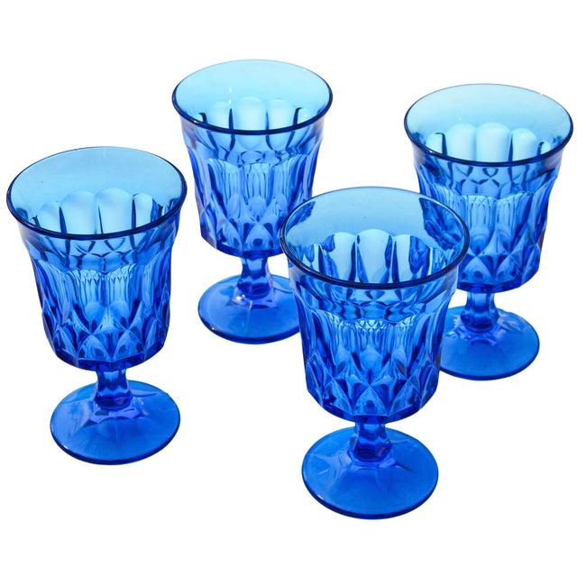 Stunning set of four midcentury handblown heavy glasses in blue, featuring a sleek sculptural silhouette with an elaborate...