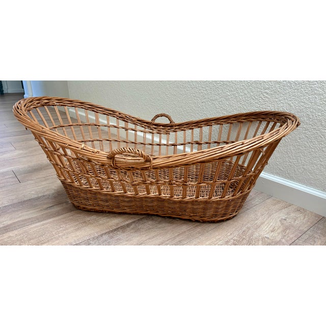 This vintage wicker basket is a French antique basket, historically used as a baby bassinet, laundry basket, or harvest...