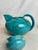 One turquoise Cierro Orvieto teapot made by Ilario Ciaurro. This lovely teapot is adorned with black semi-sheer depictions...