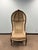 Striking high-back upholstered accent chair with an elegant arched silhouette and carved wood frame. Neoclassical-inspired...