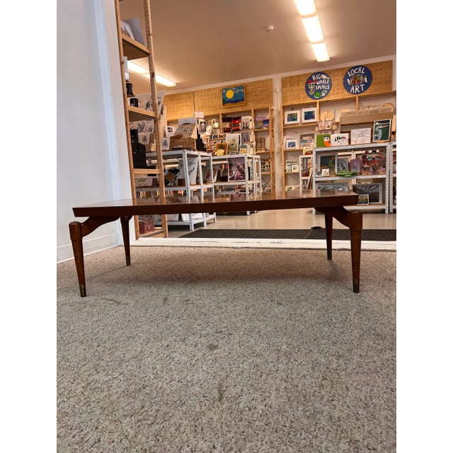 This coffee table is an iconic Mid Century rectangle shape. It's such a great design with a walnut frame and rocket shaped...