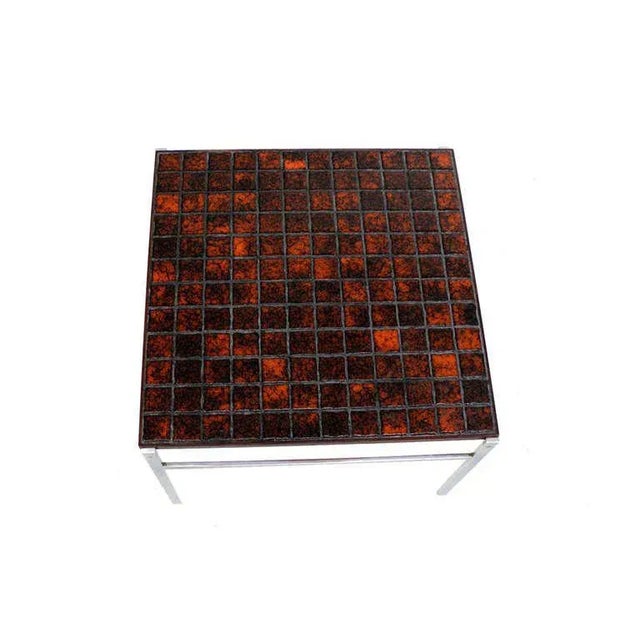 Nice square rosewood and tiled top chrome base coffee table in style of Poul Kjaerholm. This item includes restricted...