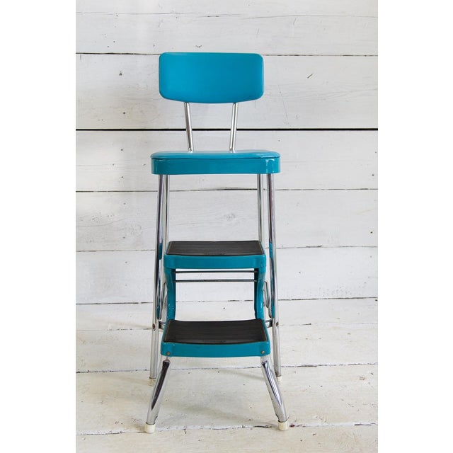 Stool with transformation into an industrial style ladder. It has a chromed tubular steel structure and has a turquoise...