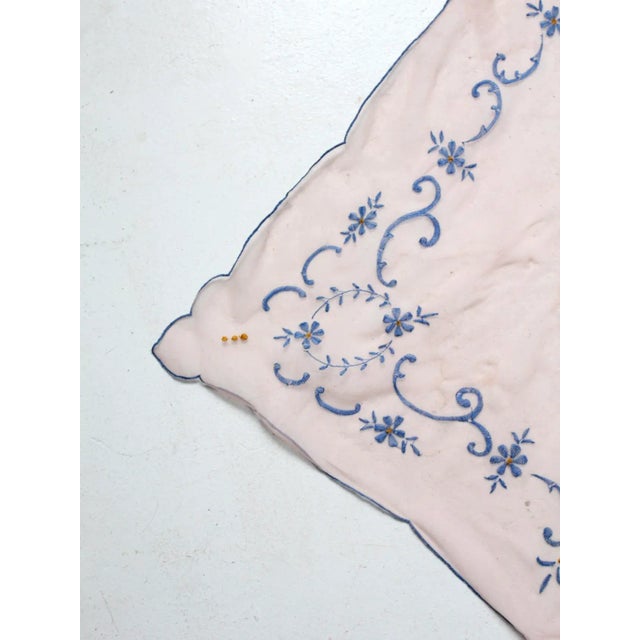 Vintage sheer pink table cover with a delicate organza-like texture and intricate embroidery. The decorative cloth is...
