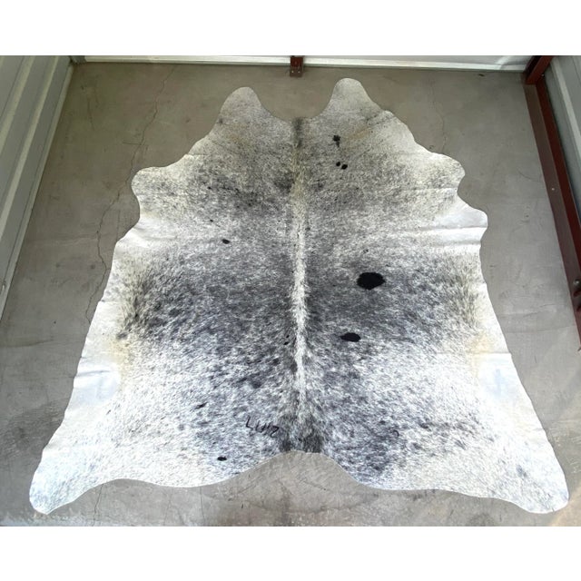 Extra large black and white natural Brazilian cowhide referred to as "salt and pepper" is a monochromatic piece that works...