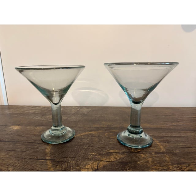 This handblown martini glass is crafted with clear recycled glass and a subtle blue-green rim. Set of 2 because they are...