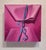 This artwork presents a close-up view of a pink package, its vibrant hues creating a sense of warmth and playfulness. The...