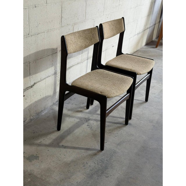 Elegant pair of Danish modern dining chairs crafted in the style of Erik Buch, featuring sculptural solid oak frames with...