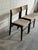 Elegant pair of Danish modern dining chairs crafted in the style of Erik Buch, featuring sculptural solid oak frames with...