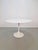 Set of 4 vintage Tulip chairs and dining table in ABS plastic and fabric in the style of Eero Saarinen Dining area with a...