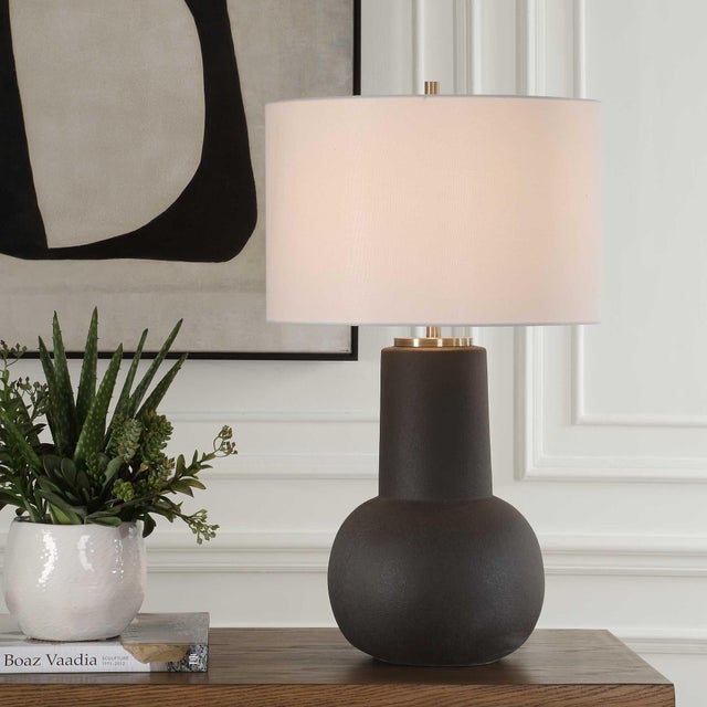 Crafted From Ceramic And Finished In A Textured Rustic Bronze Glaze, This Table Lamp Features A Distinctive And Elegant...