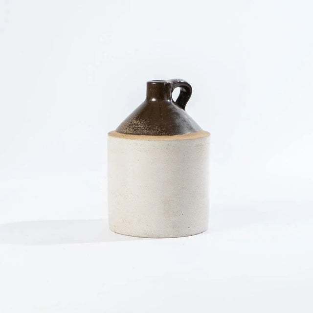 This is an antique stoneware crock jug made in the late 1800's or early 1900's. It makes a beautiful utilitarian statement...