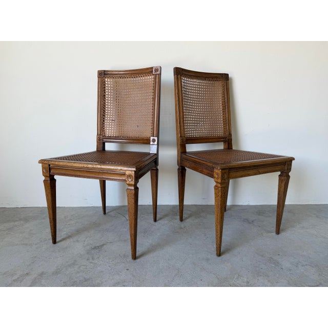 Elegant antique Italian Louis XVI–style accent chairs featuring beautifully carved wood frames and classic handwoven cane...