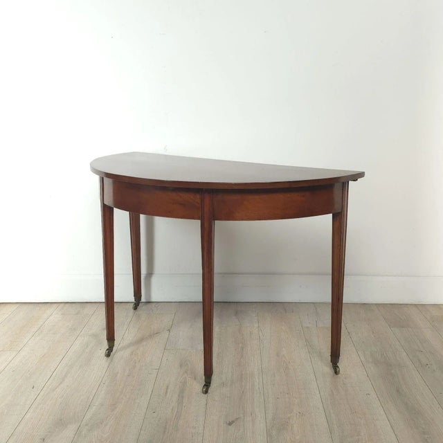 Georgian mahogany demi lune table, England circa 1800.
