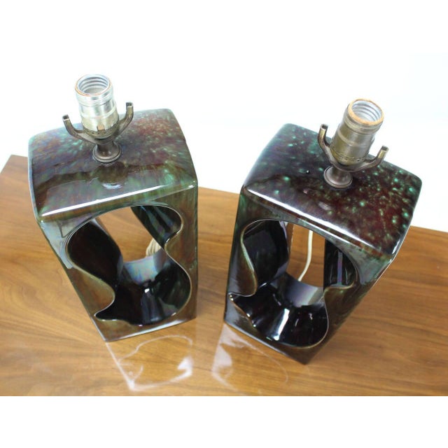 Pair of vintage circa 1970s glazed Art pottery table lamps. Dark olive green gloss glaze.