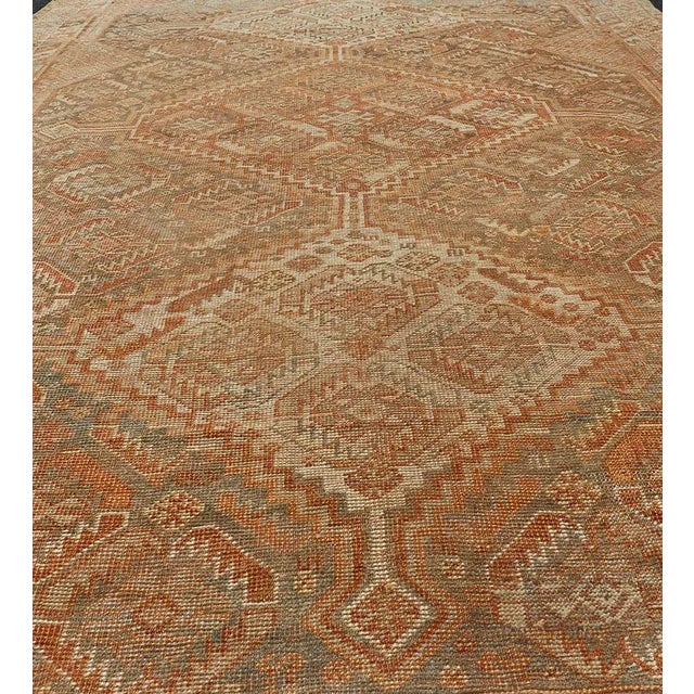Persian antique Shiraz carpet in soft orange, light gray, light rust red and light brown with geometric medallions, rug...