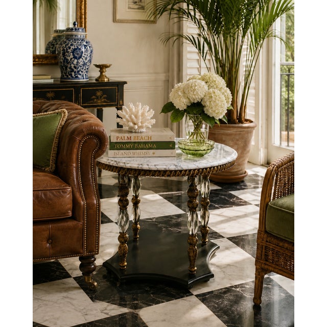 Elegant vintage accent table featuring a beautifully veined marble top supported by sculptural carved legs with decorative...