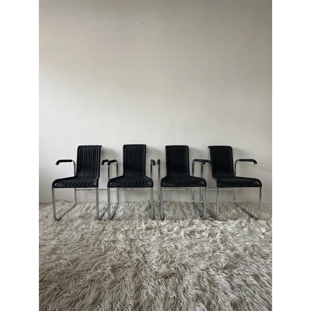 The D20 chair with armrests was designed by Jean Prouve and manufactured by TECTA. Its specially bent tubular frame and...