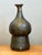 This vintage studio pottery vase is a compelling example of mid-20th-century ceramic artistry, celebrated for its...